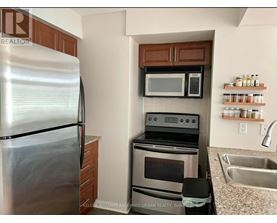 A kitchen with a stainless steel refrigerator, oven, and microwave.