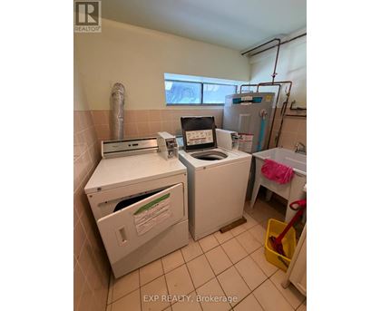 A small laundry room with a washer and dryer.