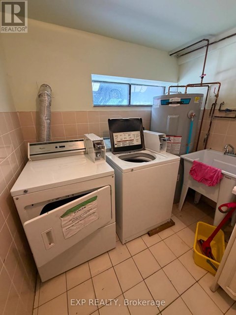 A small laundry room with a washer and dryer.