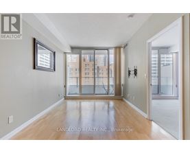 A spacious room with a view of a cityscape through the windows.