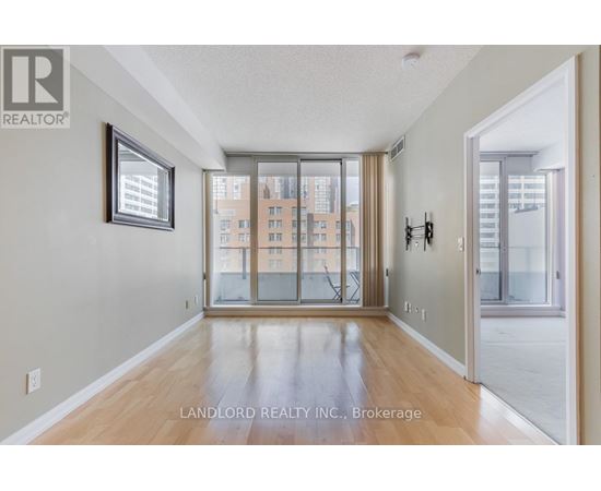 A spacious room with a view of a cityscape through the windows.