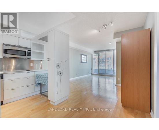 A kitchen with white cabinets and a microwave above the stove.