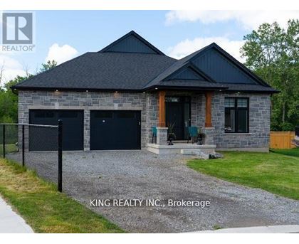 A house with a black roof and stone exterior is for sale in Brokerage by King Realty INC.