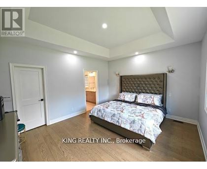 A bedroom with a bed, dresser, and mirror.