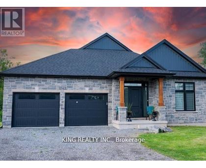 A house with a stone facade and two garage doors is for sale in Brokerage, North Carolina.