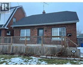 A house with a brick facade and a wooden fence.