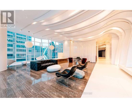 A spacious living room with a curved ceiling and modern furniture.