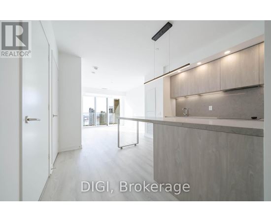 A modern kitchen with white cabinets and a countertop.