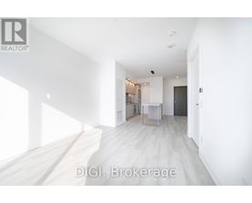 A room with white walls and a wooden floor is shown.