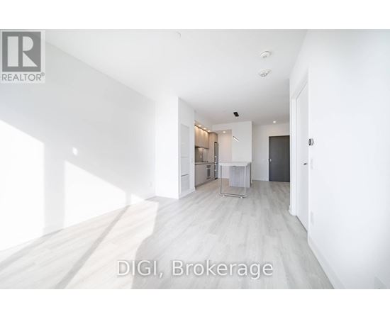 A room with white walls and a wooden floor is shown.