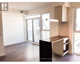 A realtor photo of a kitchen with a black counter.