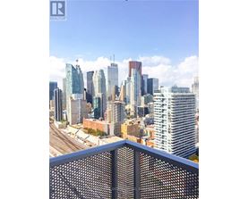 A cityscape with tall buildings and a clear sky.