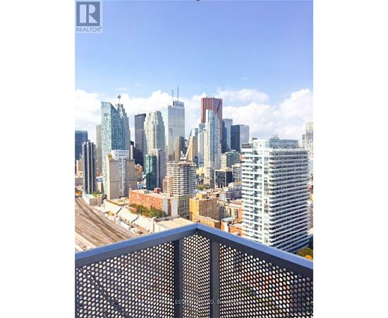 A cityscape with tall buildings and a clear sky.