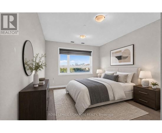 A well-lit bedroom with a large bed and a window overlooking the outdoors.