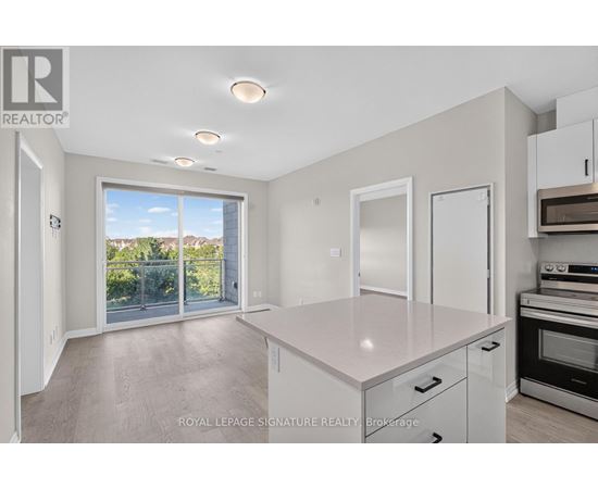 A spacious kitchen with white cabinets and a large island.