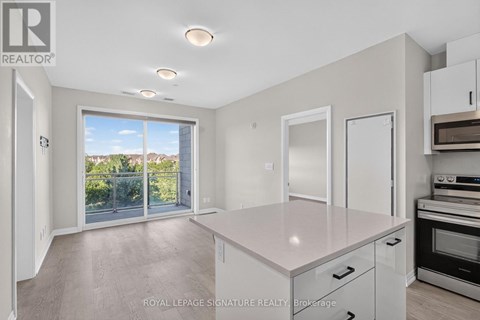 A spacious kitchen with white cabinets and a large island.