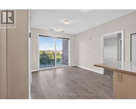 A spacious room with a sliding glass door leading to a balcony.