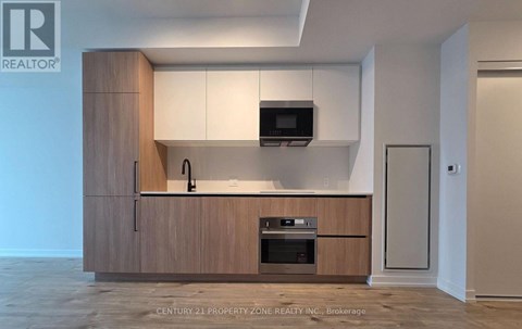 A modern kitchen with wooden cabinets and appliances.