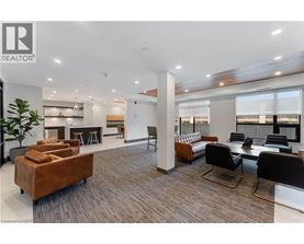 A modern office space with a brown sofa and black chairs.
