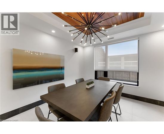 A modern dining room with a wooden table and chairs.