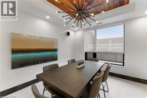 A modern dining room with a wooden table and chairs.