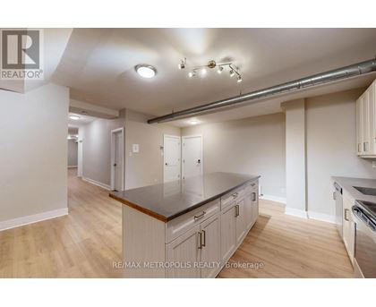 A kitchen with a counter top and cabinets.