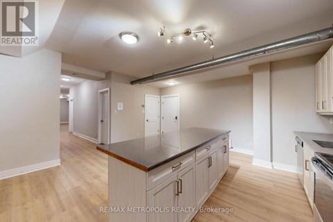 A kitchen with a counter top and cabinets.