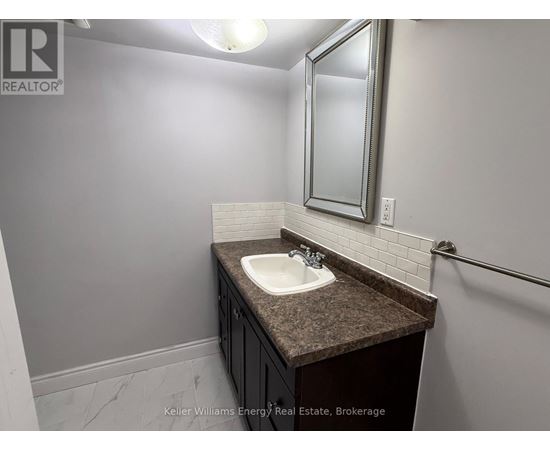 A bathroom with a sink and mirror.