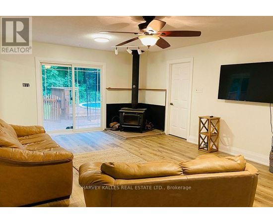 A living room with a fireplace and a television.