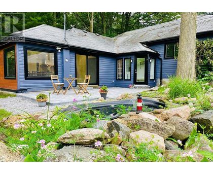 A blue house with a patio and a fire pit.
