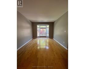 A room with wooden floors and a stained glass window.