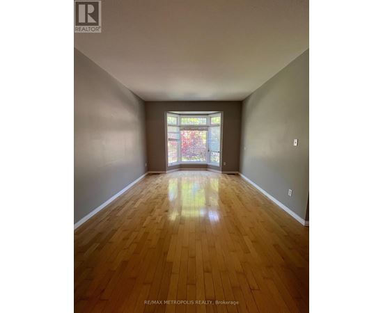 A room with wooden floors and a stained glass window.