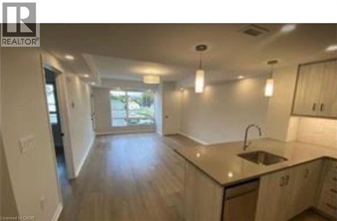 A kitchen with a sink and cabinets.