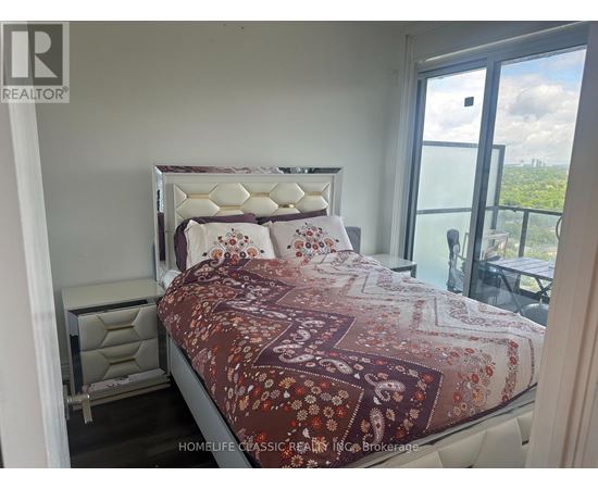A bedroom with a large bed and a view of the city.
