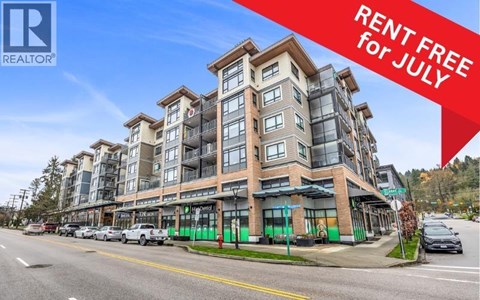 A large building with a sign offering free rent for July.