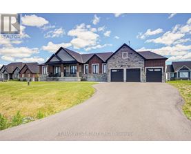 A real estate company is advertising a property with a large driveway and multiple garages.