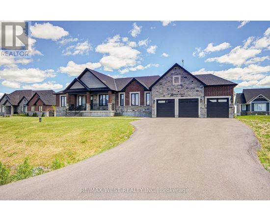A real estate company is advertising a property with a large driveway and multiple garages.