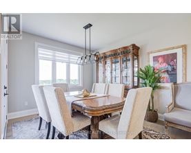 A dining room with a wooden table and chairs.