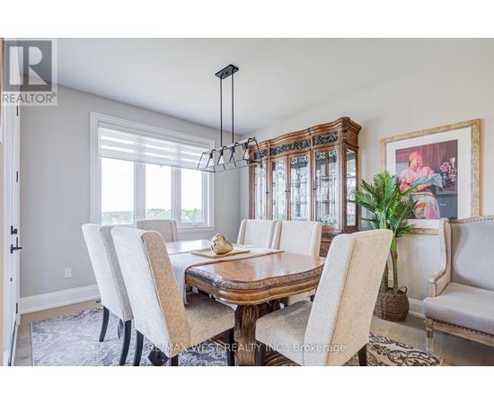 A dining room with a wooden table and chairs.