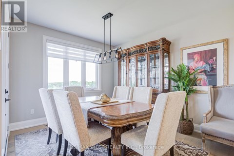 A dining room with a wooden table and chairs.
