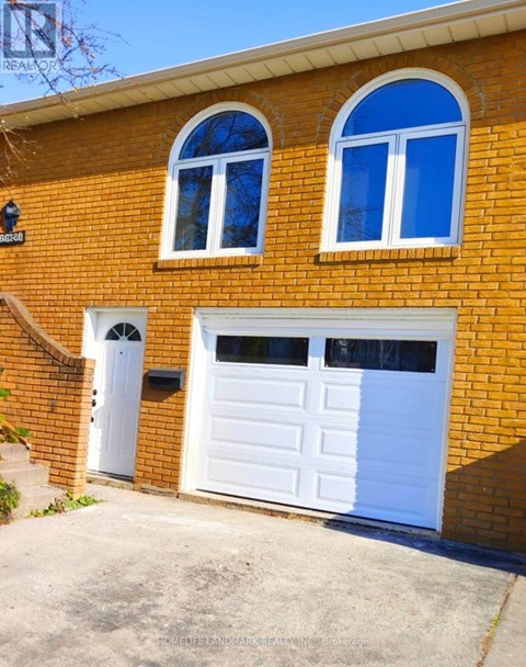 A red brick house with a white garage door.