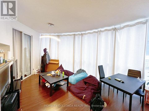 A living room with a table and chairs.