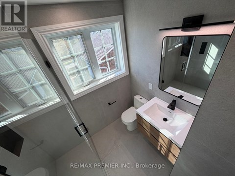 A bathroom with a skylight and a sink.