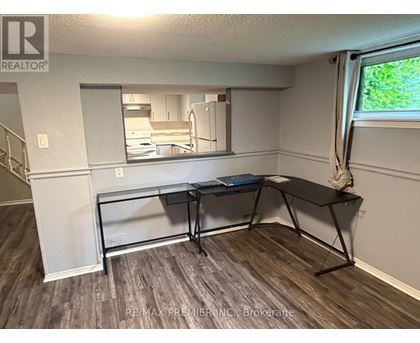 A room with a desk and a mirror on the wall.