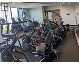 A gym with a row of treadmills.