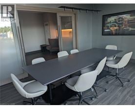 A conference room with a long table and chairs.