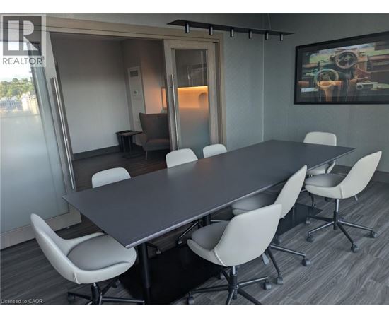 A conference room with a long table and chairs.