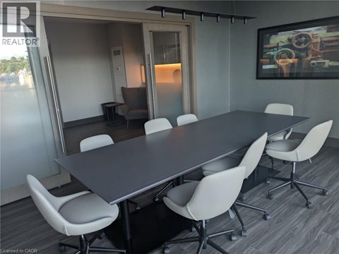 A conference room with a long table and chairs.