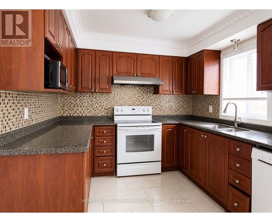 A kitchen with wooden cabinets and a white stove top oven.