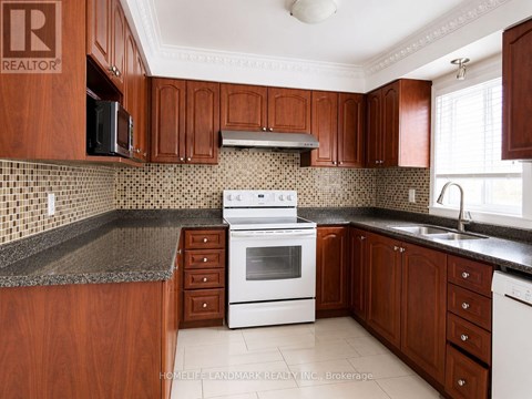 A kitchen with wooden cabinets and a white stove top oven.